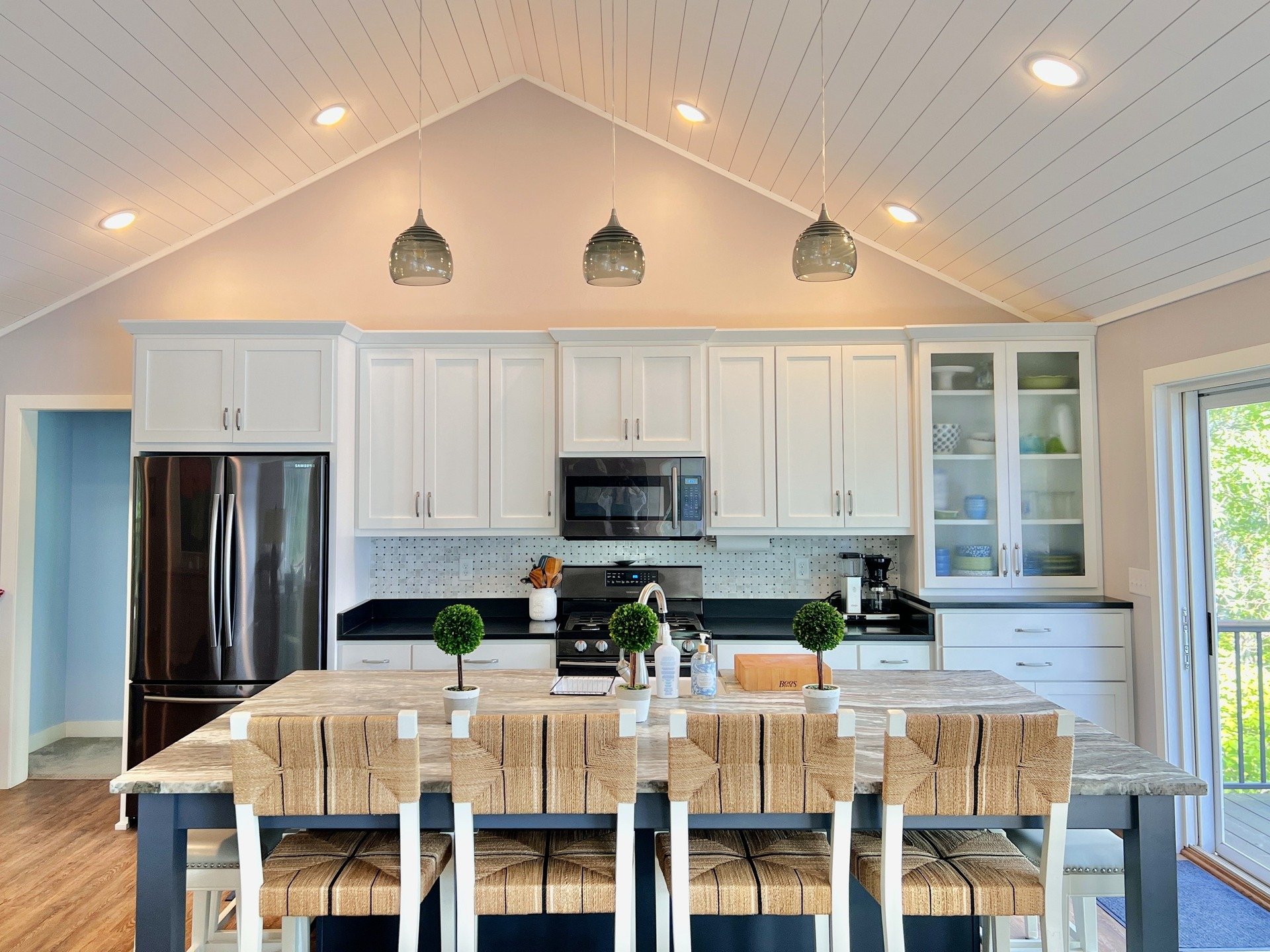 In this lake home, bright white cabinetry sets a timeless foundation, while a bold blue island and layered countertop finishes add character and contrast.

#kitchendesign #interiordesign #designinspo #customkitchen #lakehome #lakehousestyle #lakehome