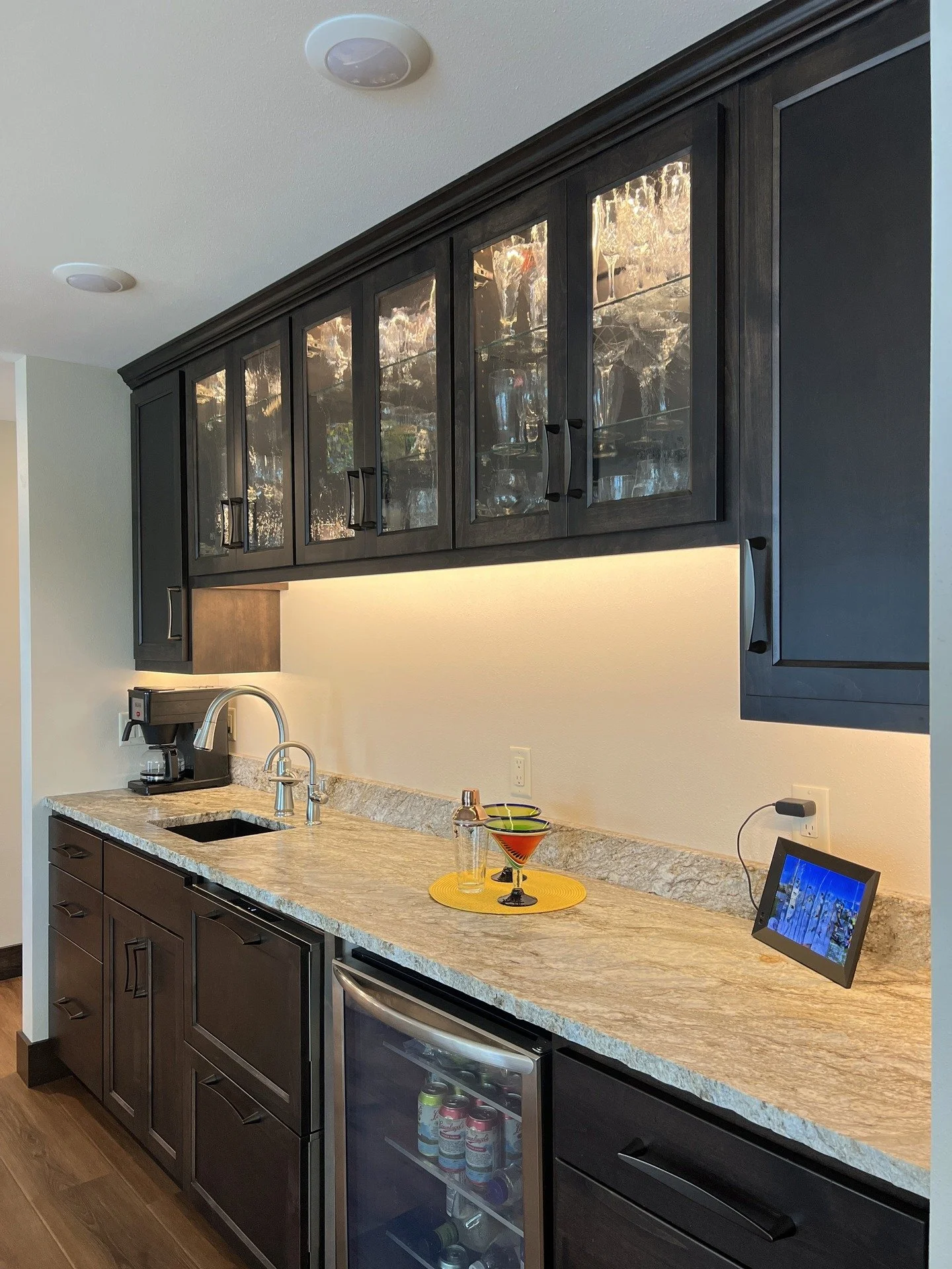 Moody, modern, and made for entertaining. 
Textured glass uppers and deep stained cabinetry set the stage for this custom built in bar.

#woodworking #customcabinetry #custombar #builtins #barinspo #homedesign #interiordesign #mninteriors #parkrapids
