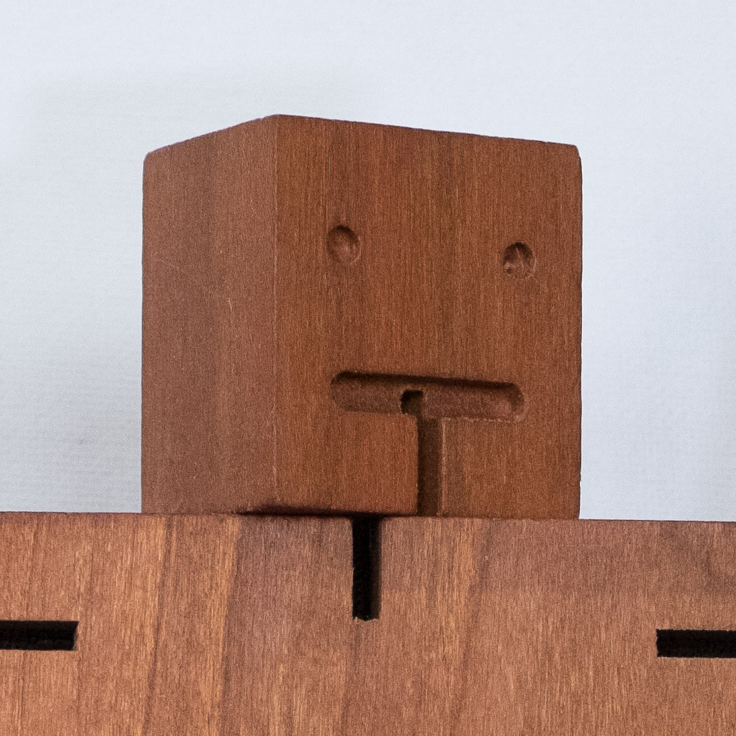 ISO 6400. The high ISO shows more noise and muddies the wood grain detail.