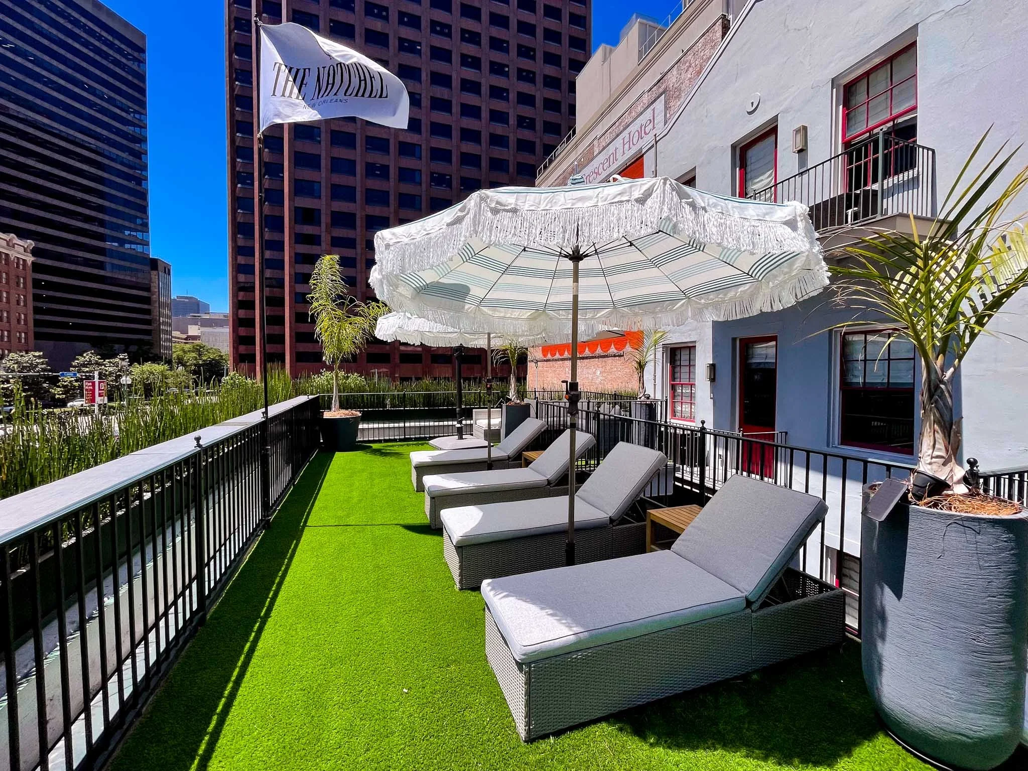 Rooftop sun deck with the Natchez flag and downtown skyline