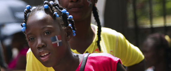 Dominicans of Haitian descent with the Dominican flag painted on their cheeks demonstrate in front of the Central Electoral Board to demand their Dominican citizenship in Santo Domingo on March 12, 2013. AFP PHOTO / Erika SANTELICES | Getty