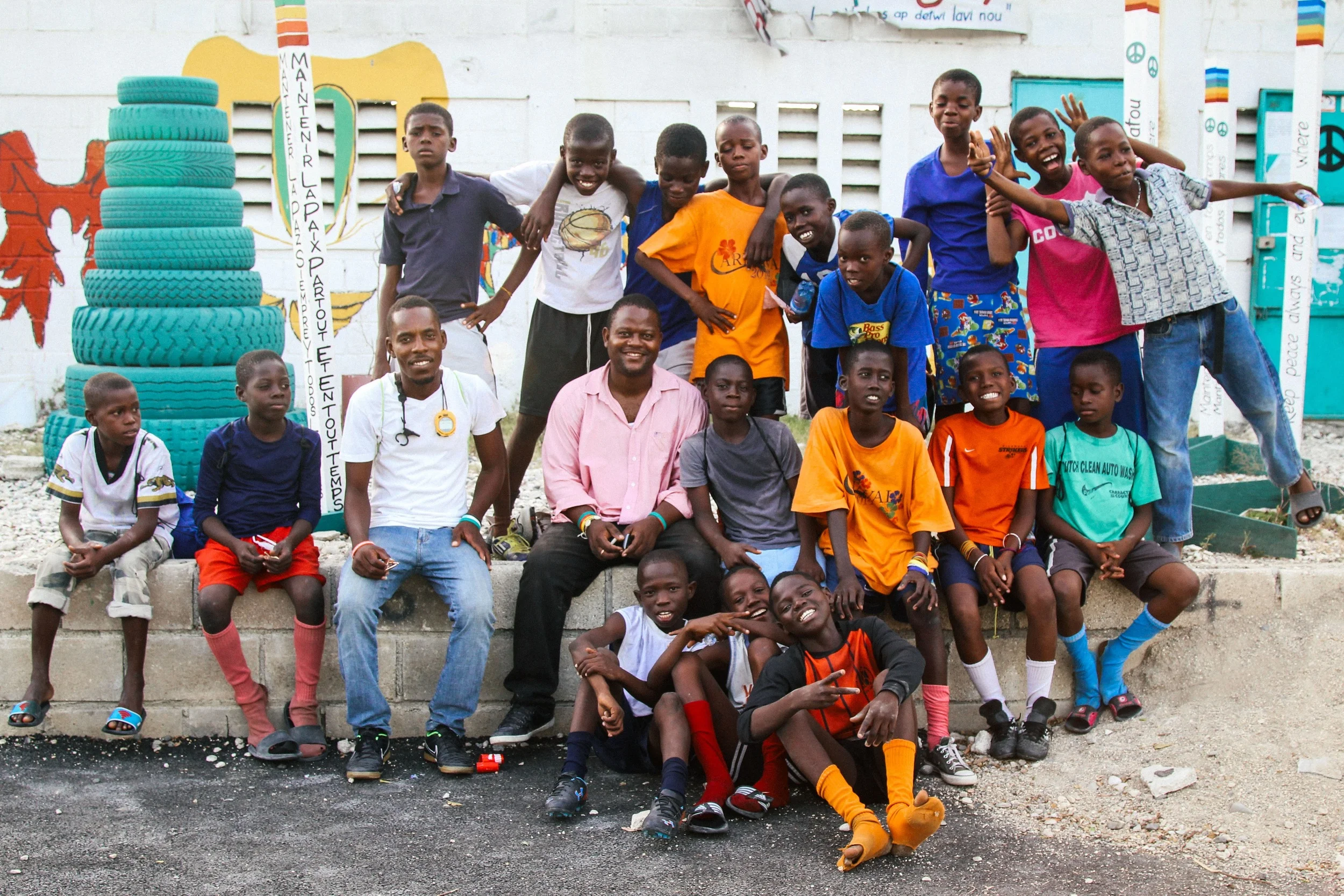 Both teams pose at the end of practice with Coach Fils-Aimé and Felder Jean Paul (at center), one of the members of SAKALA's leadership.