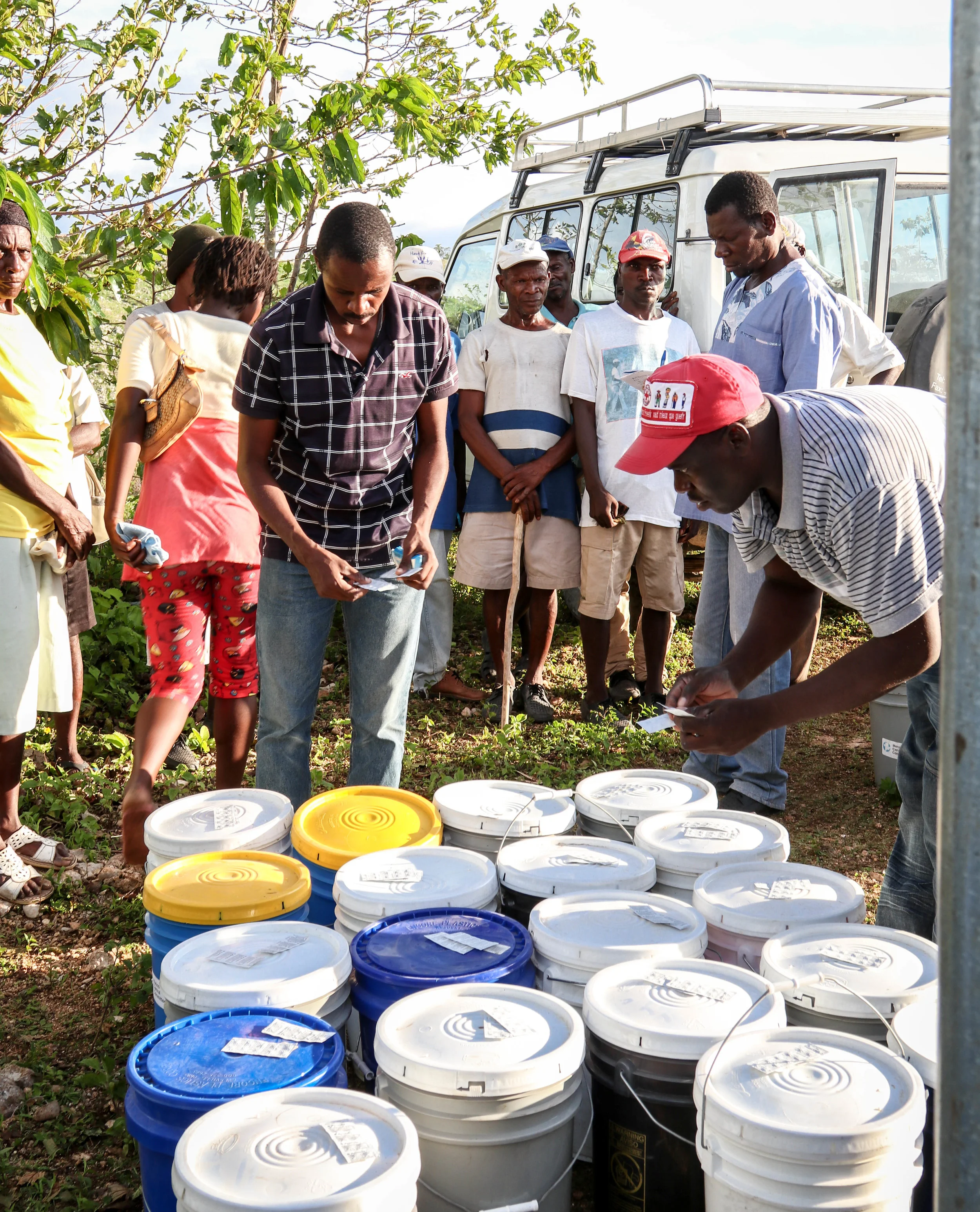 MCC staff prepare relief kits for distribution along with members of an affected community.
