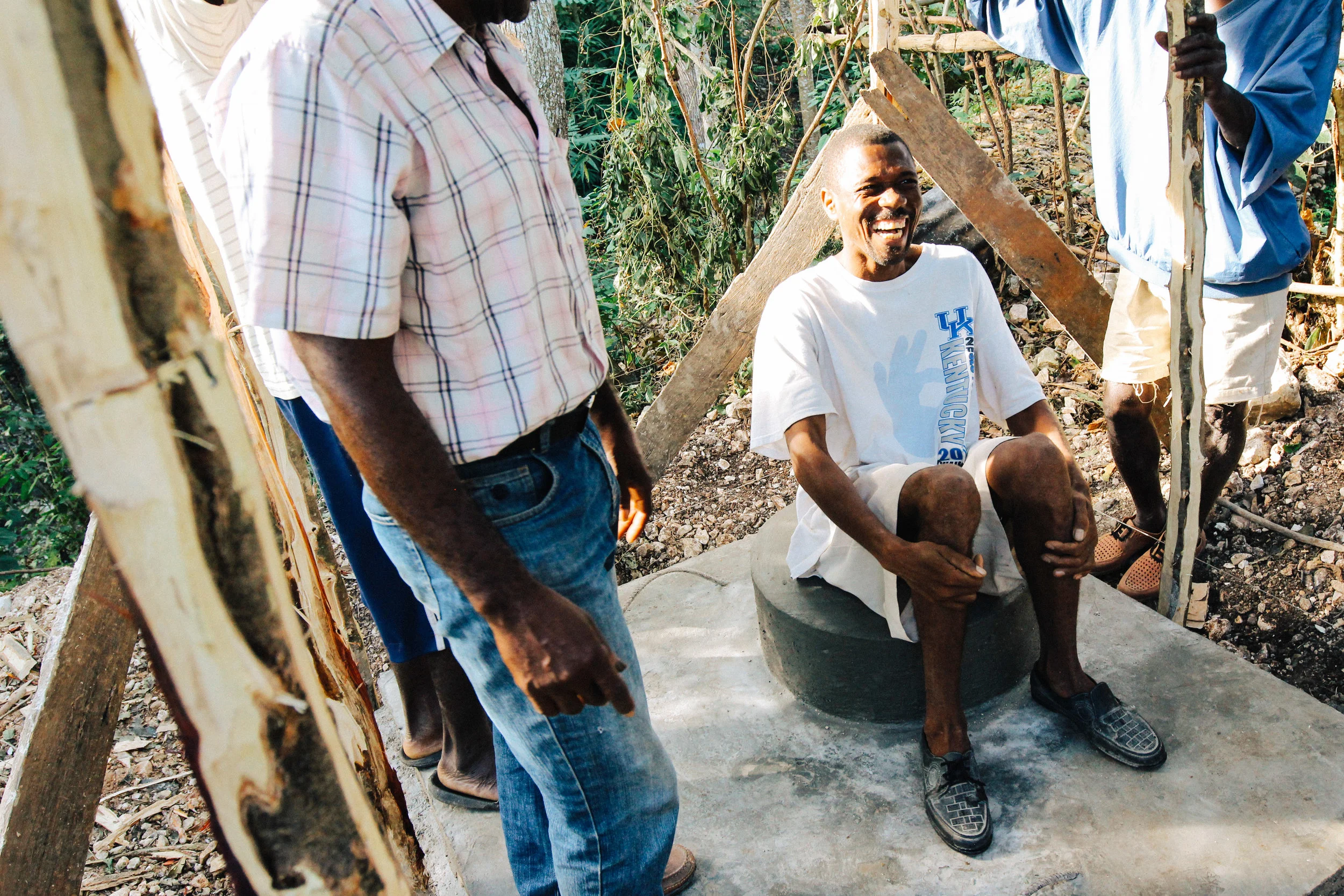 The assembled group burst into laughter as Desinord Petide, the owner of the community's first latrine, pretended to model the its use.