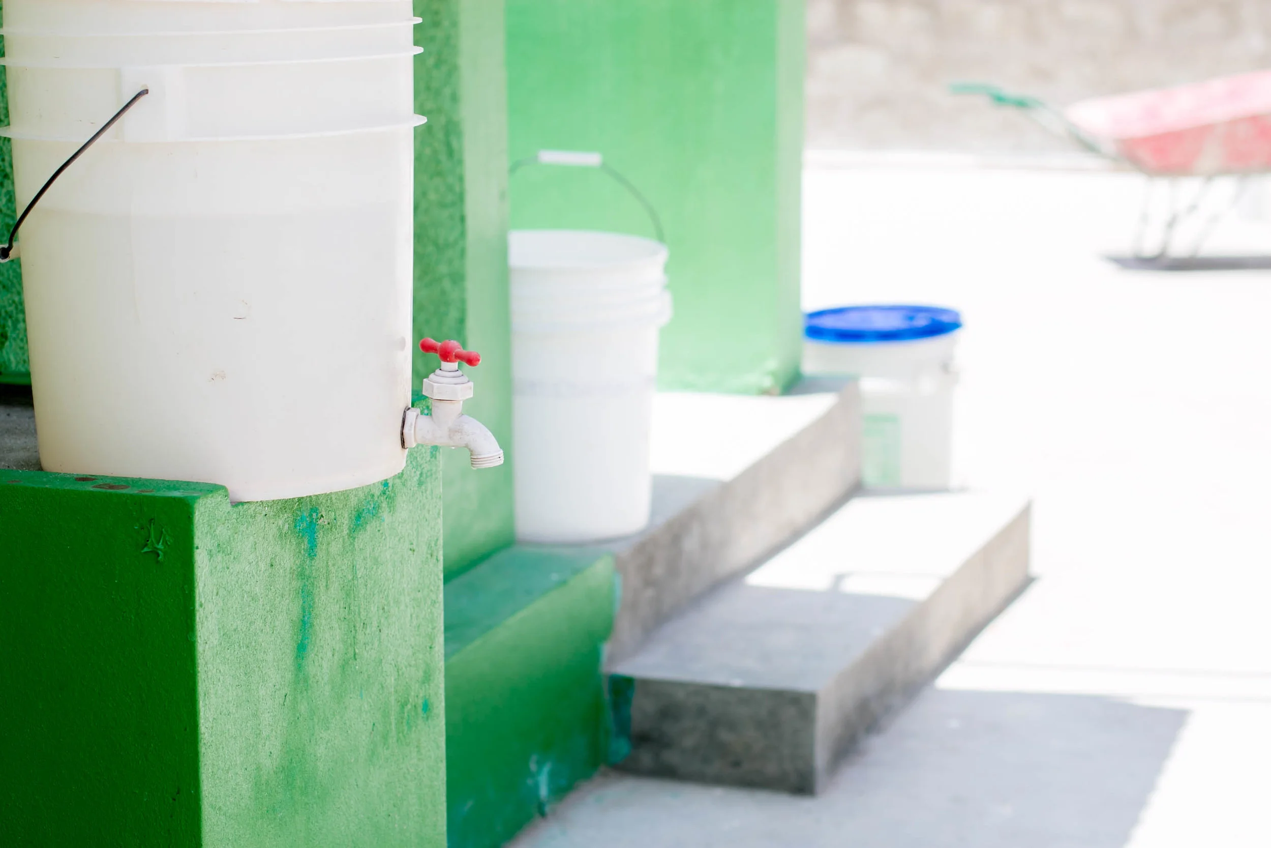 Sanitation buckets at the Cholera Treatment Center in Verrettes are placed at all entrances and exits for hand and foot washing for both staff and visitors. The buckets contain chlorinated water and are intended to stop the spread of cholera throughout the facility and to the outside community. MCC paid for the rehabilitation and rebuilding of the Cholera Treatment Center.