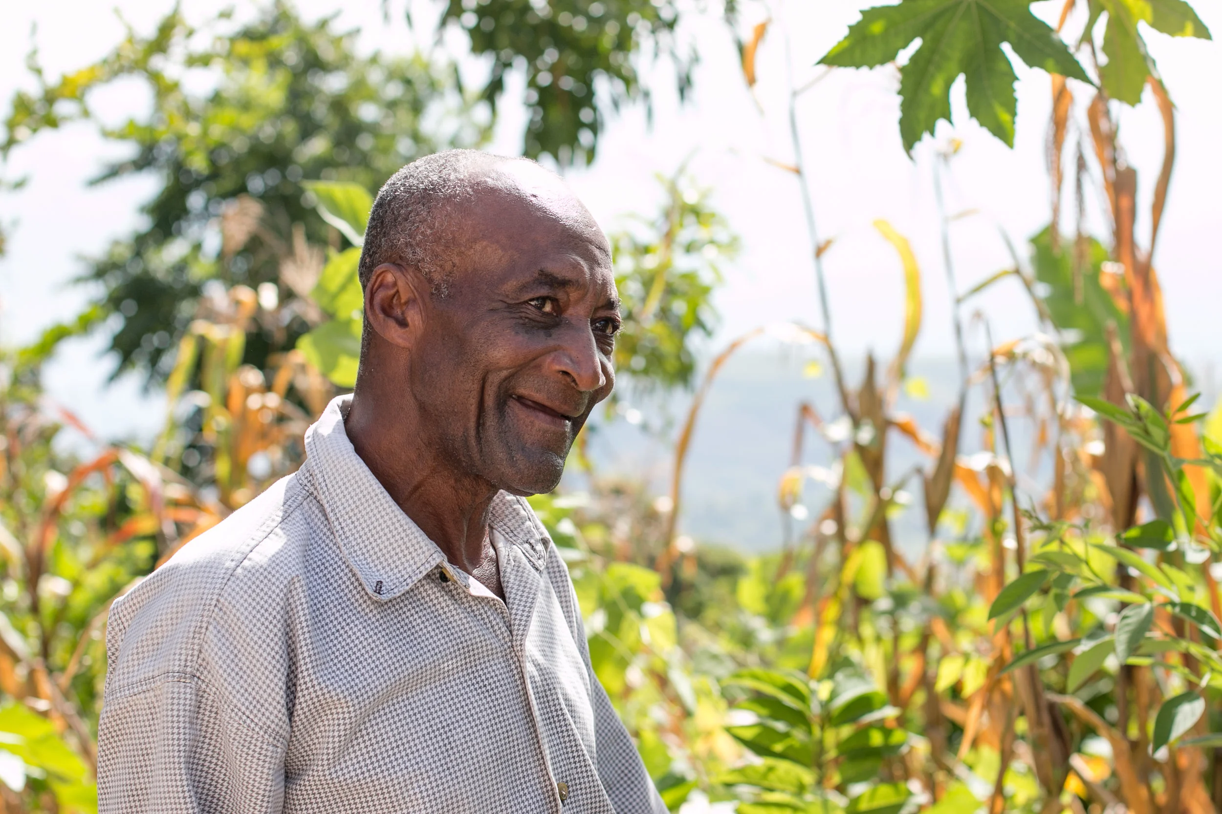 Antoine Calix in front of his garden in the community of Wondo, where MCC helped residents rebuild their gardens after Hurricane Matthew.