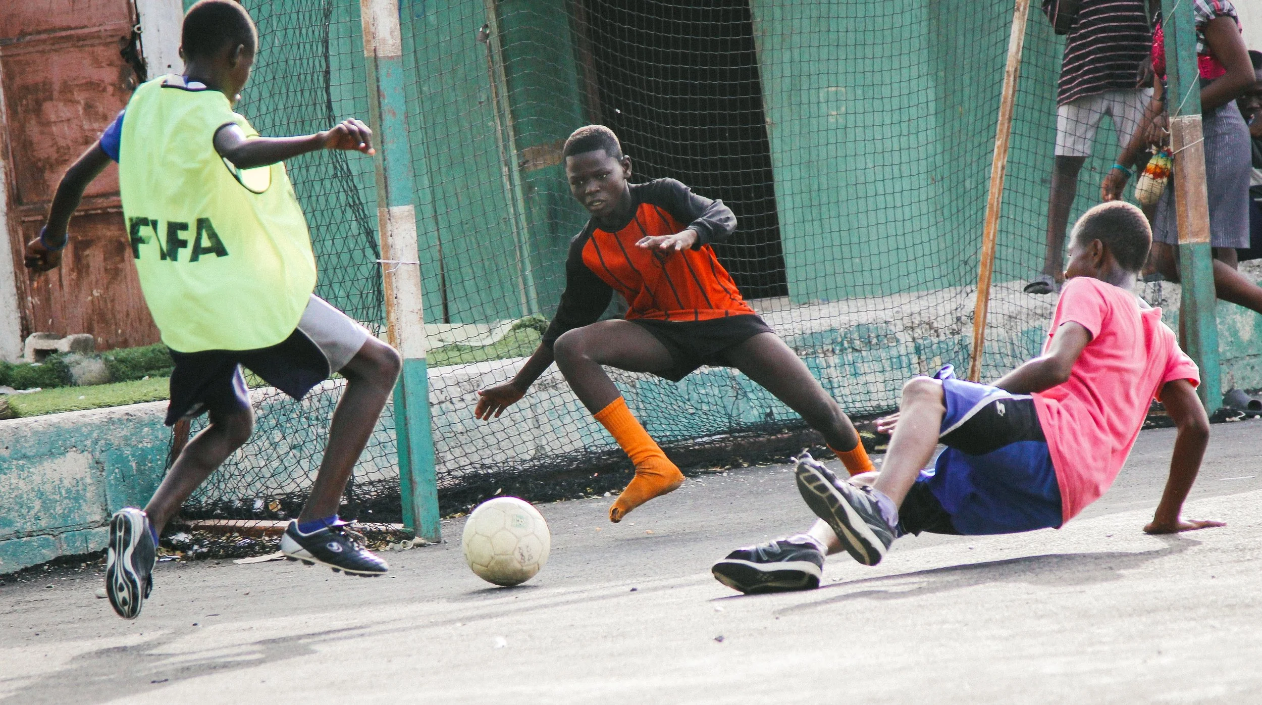 Participants play soccer at the SAKALA community in Cité Soleil.