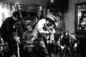 Vernon playing washtub bass with The Pine Hill Haints (2001) From Vernon, " 2001 or so at End of the Line Cafe in Pensacola. It had to be one of the first tours after the Haints reformed because it was when Ted and Rymodee from This Bike is a Pipe Bomb were in the band."