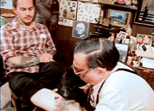 Film still from "Stoney Knows How" of Stoney tattooing the Legendary tattooist Don Ed Hardy (1980)