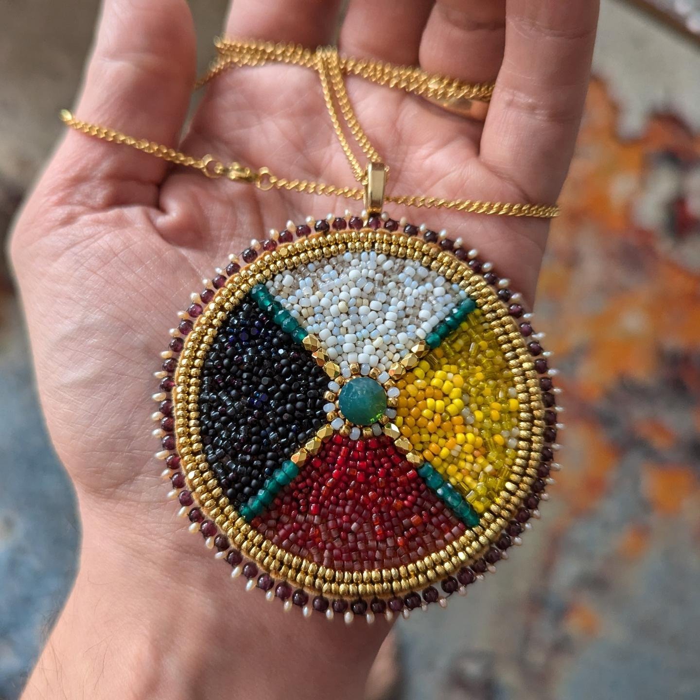 Luxurious small medicine wheel medallion with large Swarovski crystal centre, 24k gold faceted beads. Edged with garnet and seed pearls. Backed with birch bark. **Sale pending