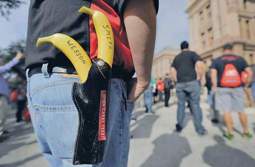 Jason Greene locked and loaded with a pair of bananas marked "Smith" and "Wesson" at a rally in support of open carry laws in Texas in 2015. AP/Eric Gay