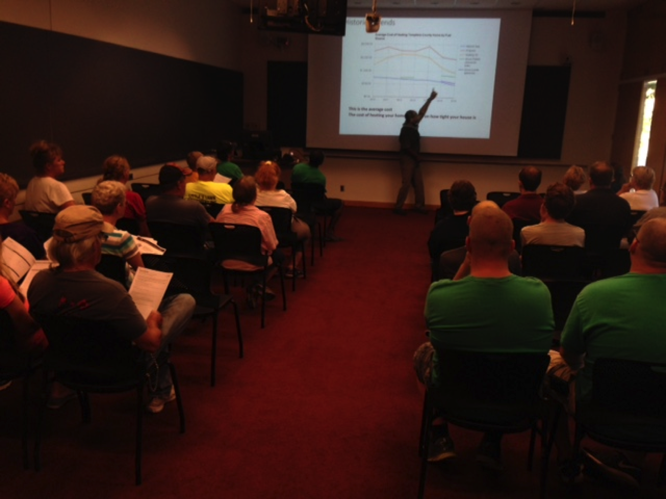 Booker presenting to a group of Building Care workers on different heating options.