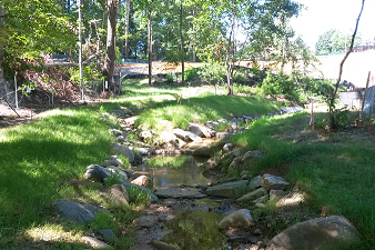 After: Channel bed was raised to reconnect to the floodplain using a reinforced bed material that included natural boulders and cobbles. The stream serves as a centerpiece of the Millennium Expansion, making aesthetics a very important component of the restoration.