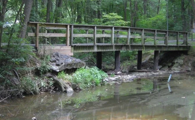 Unstable bridge abutments where erosion has widened the stream channel
