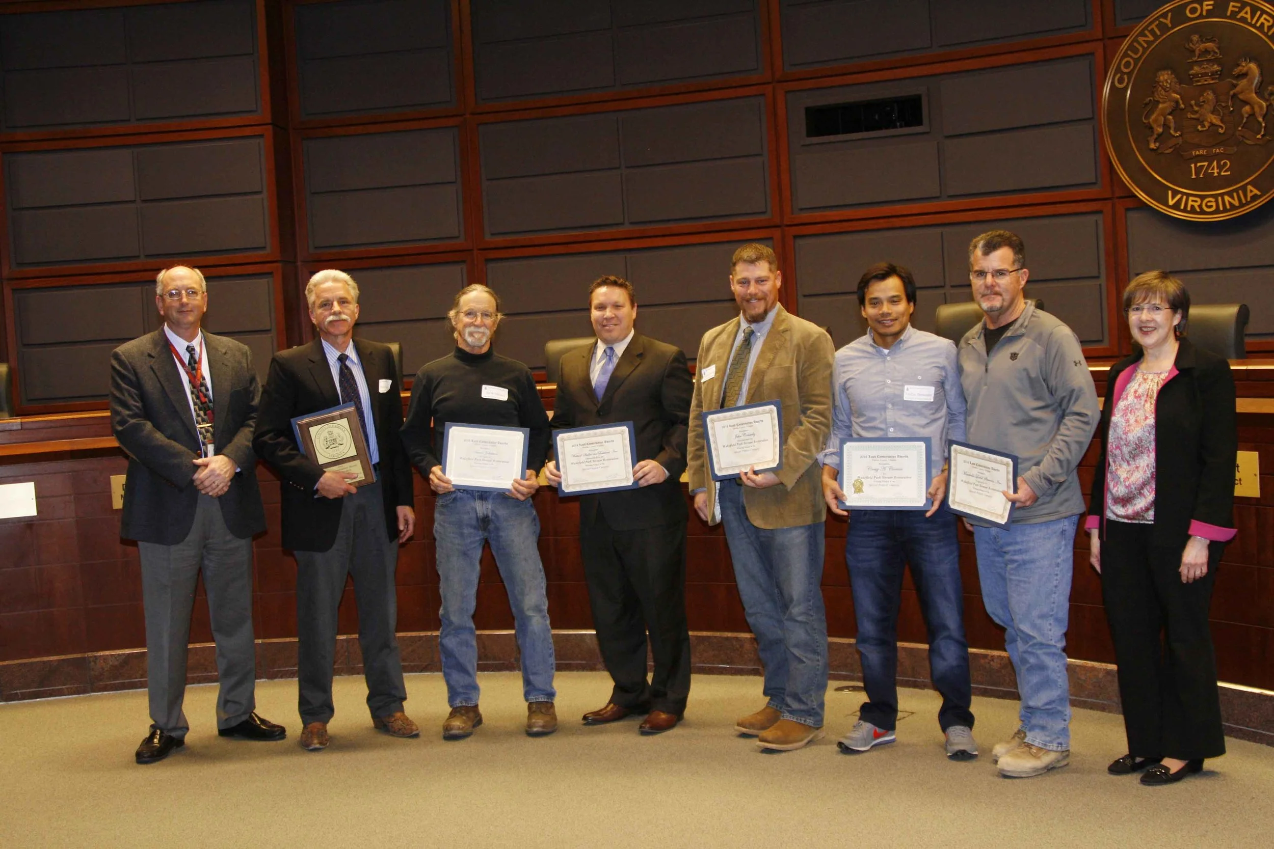 J.T. Kelley and Jason Beeler (center) accepted the award from Fairfax County on behalf of WSSI.