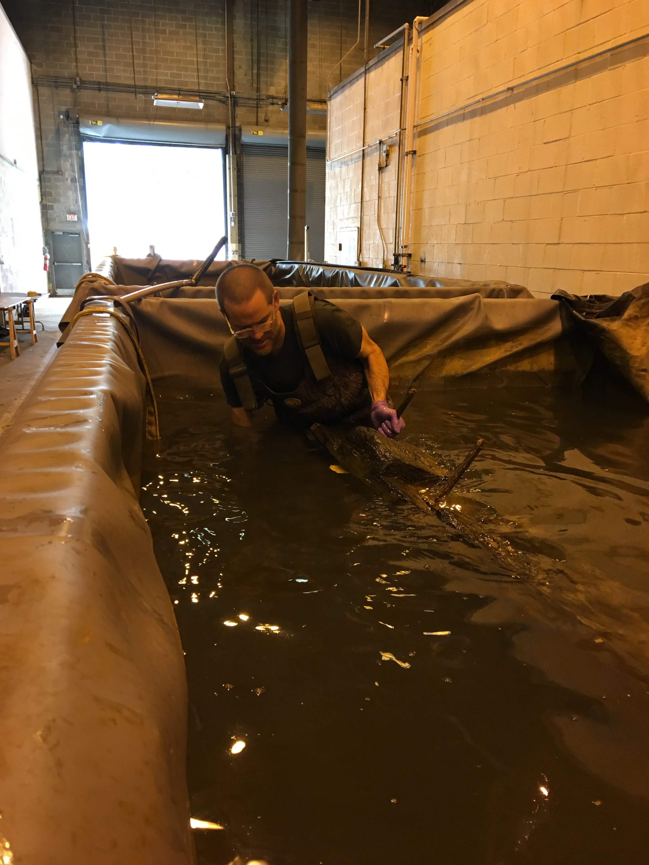  WSSI archeologist Ed Johnson helps as timbers are lifted from conservation tanks.  In June 2017, Ed and other volunteers removed timbers from their tanks, carefully packed them, and sent them to Texas A&amp;M University's  Conservation Research Labo