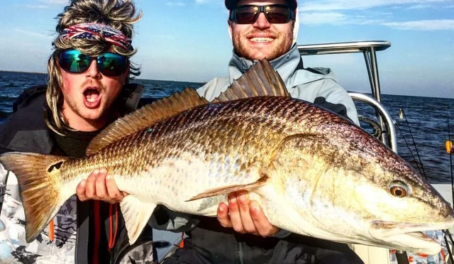 Fly fishing personality Billy Chesapeake and his fishy fellow friend with a jaw-dropping red.