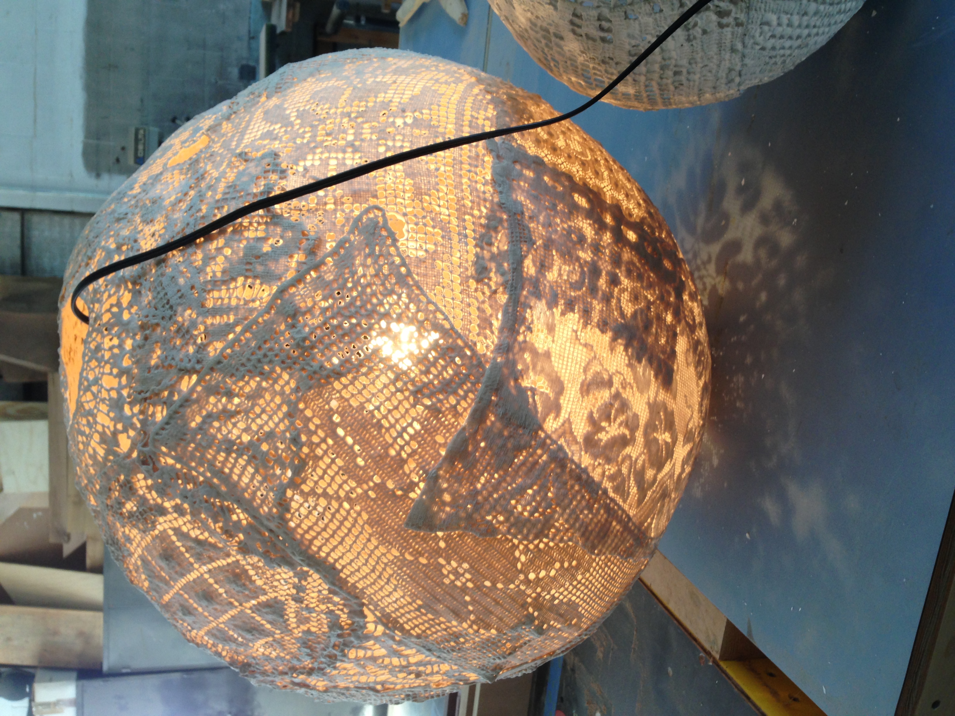 This is a lantern made of doilies, illuminated.