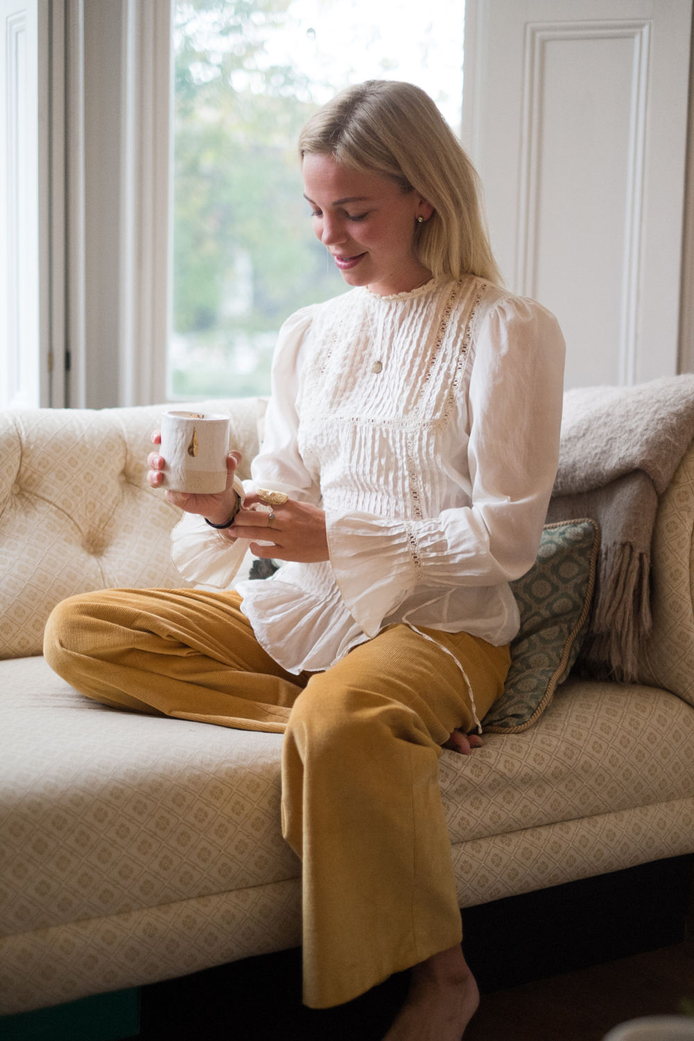 Zoe wears the Sunshine Pendant in Brass