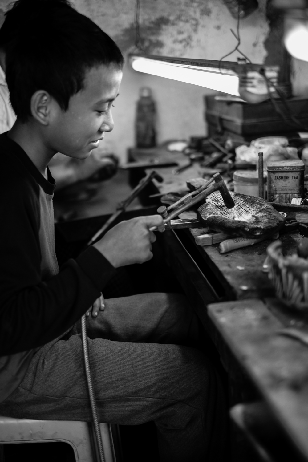 Young boy in Myanmar learning the trade.