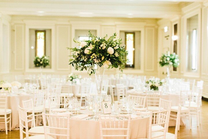 Laura and Bryan wanted classic, clean and simple so we paired white chiavari chairs, white textured linens and the most beautiful arrangements by @laruefloral.  The clear glass vases make cross-table conversations possible and the varying heights cre