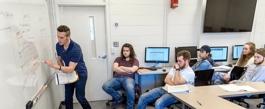 English 1020 students participating in an in-class norming session for sample research presentations.