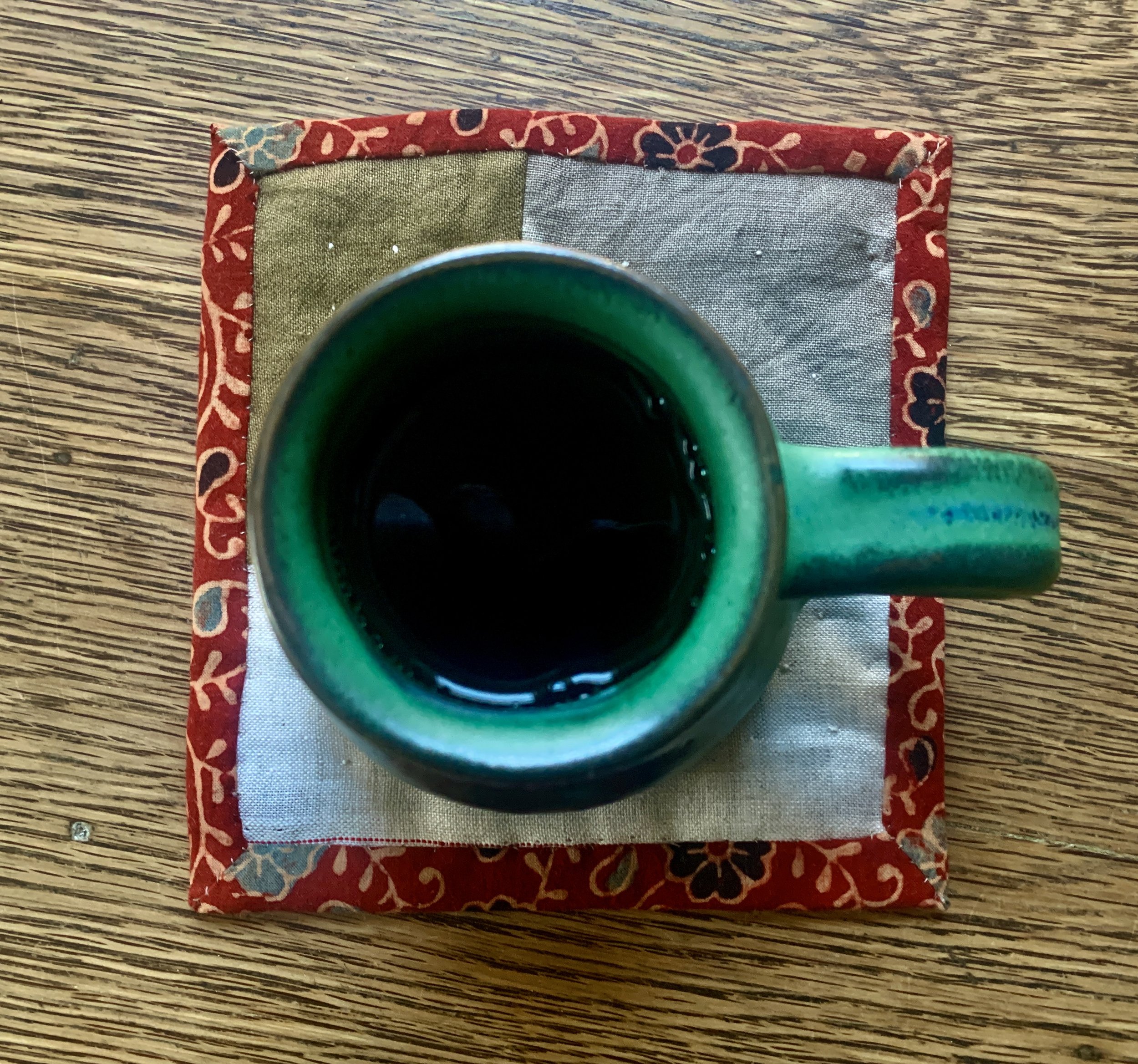 handquilt a tea mat with coffee mug.jpg