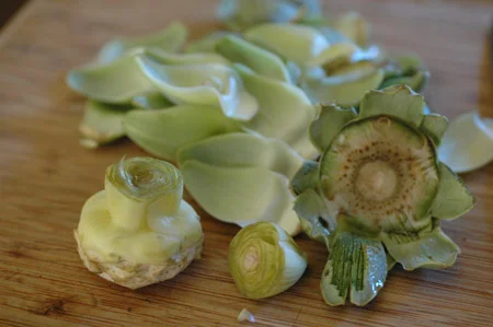 prepping artichokes for canned artichoke hearts . It was a big artichoke year, mostly because I was on top of controlling the voles who like to munch on the plant bases. They aren’t hard to control with apple slices in mouse traps, it just has to get done.