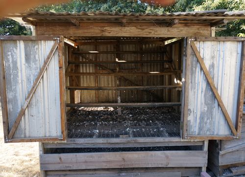The PoopCoop! This coop was my idea, designed and built by tonia. It has a 1x2 inch galvanized wire mesh floor and a wooden subfloor. The subfloor is well ventilated and can be accessed for poo removal from the front and back. There are boards screwed on the access points to keep the chickens from getting in there scratching around for bugs. I would make the access slots a little taller for easier access, maybe with doors instead of boards screwed on. Otherwise, it works pretty great. Make sure you orient the wire and the boards on the drying floor in the right direction for easy scrapping, otherwise you get a washboard effect.