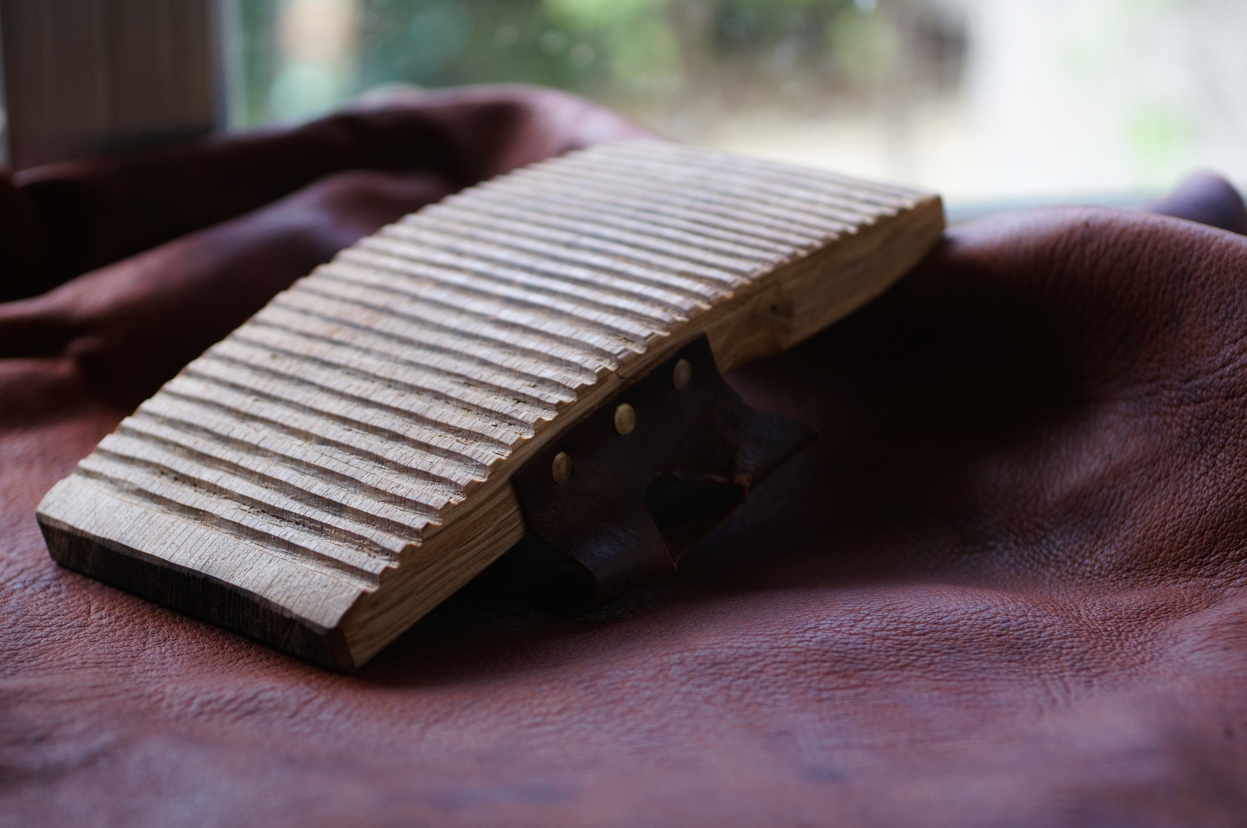 Graining board for softening and raising the grain of leather.