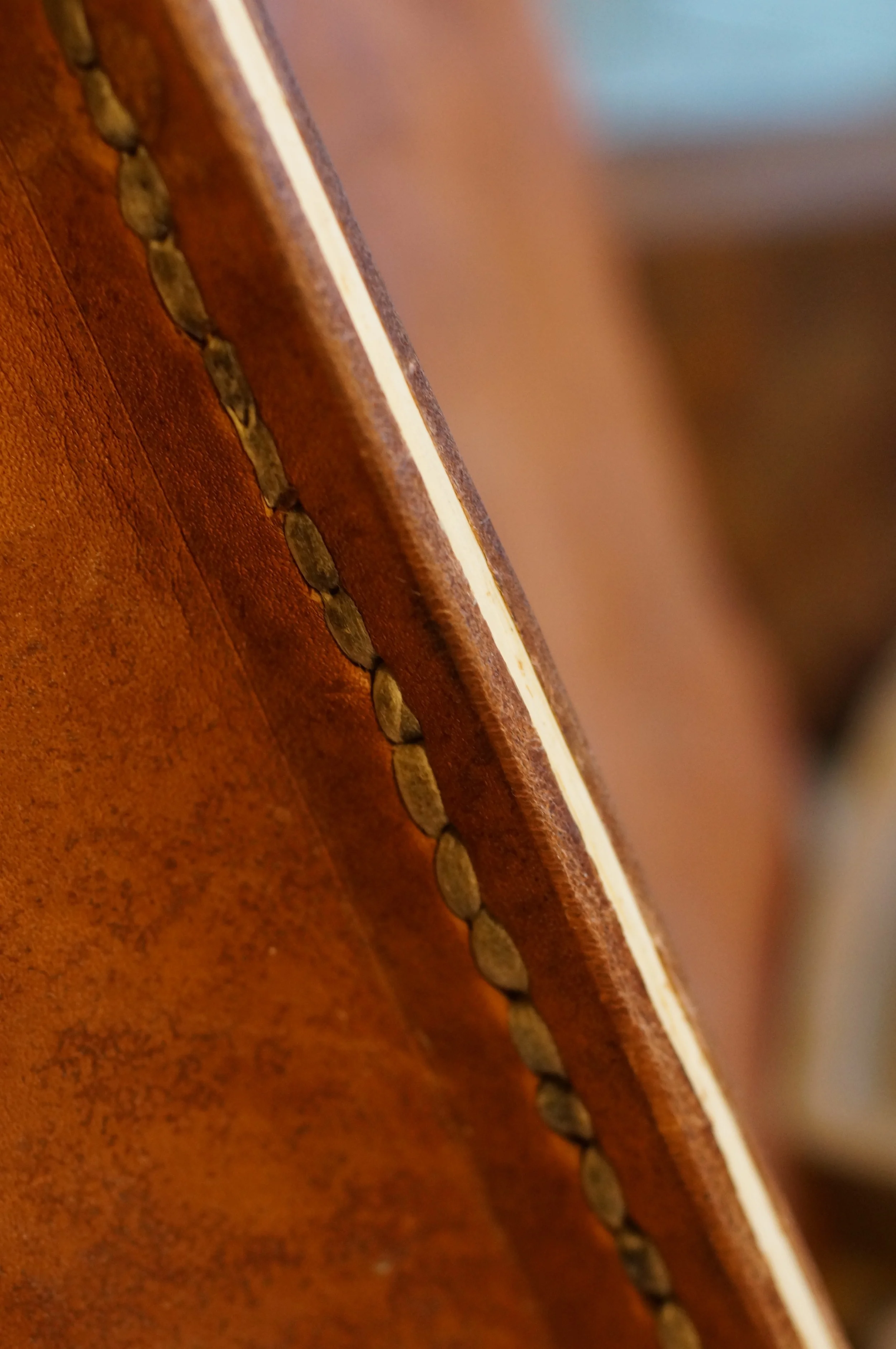 A wood and leather seam with rawhide stitching. An experiment for another abandoned project.