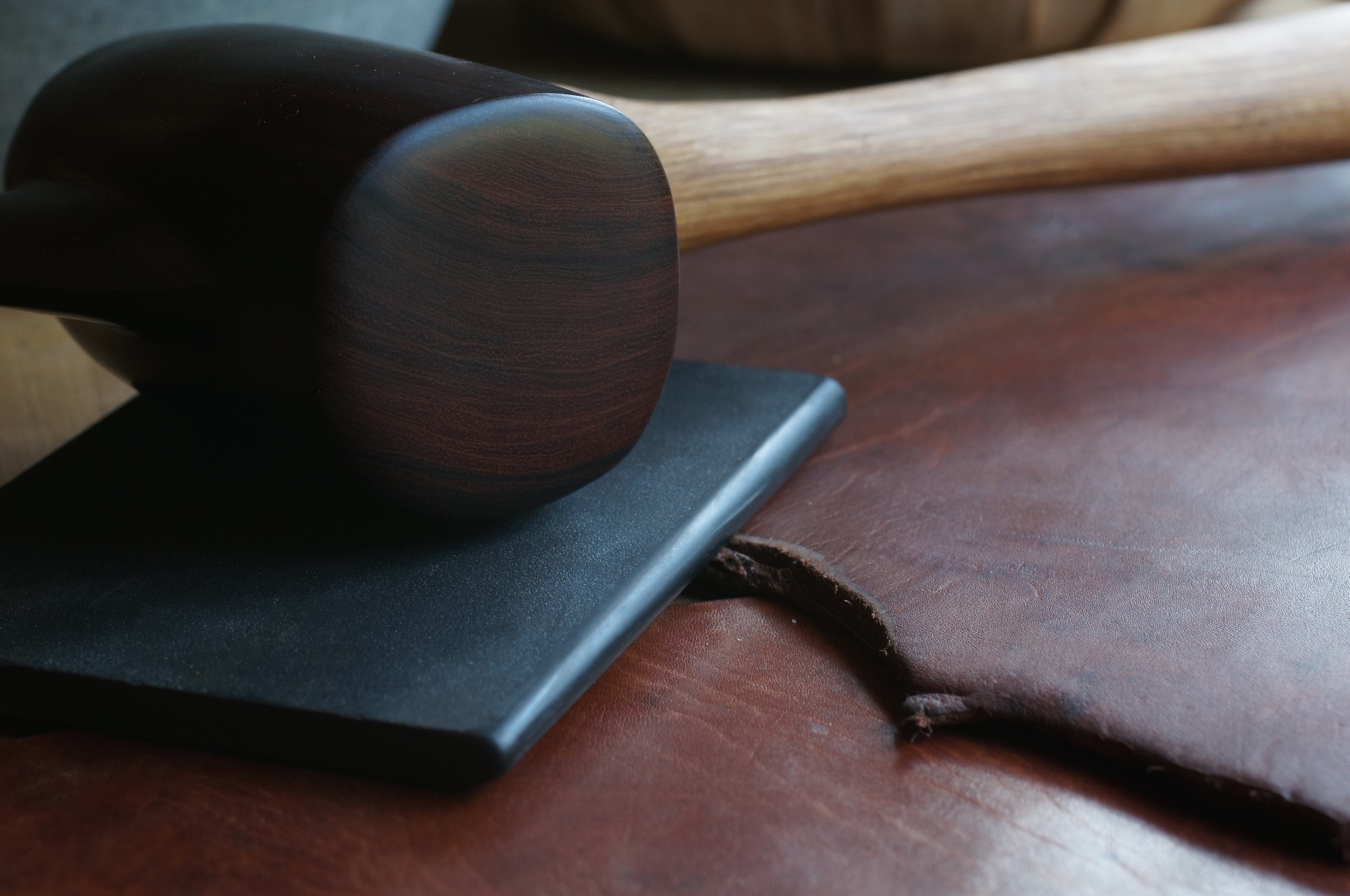 Pounded leather, half the thickness, twice the density. The mallet is ironwood, extremely dense. The slate is used to smooth and even the surface after pounding. pounding is done on damp leather