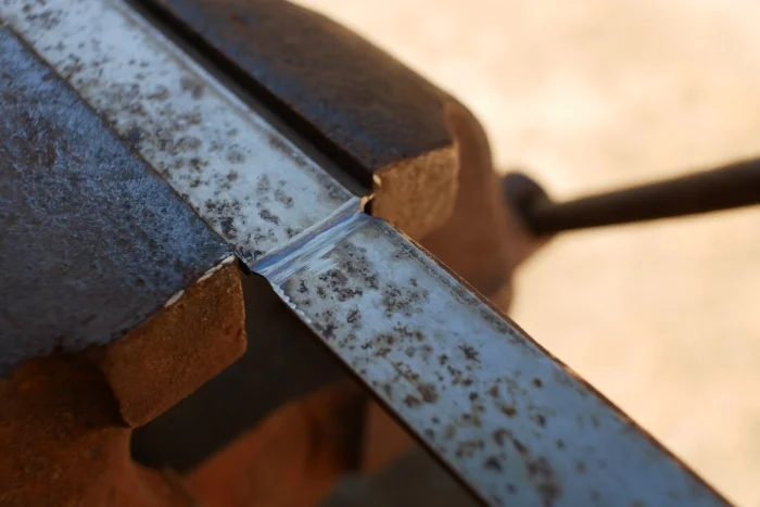 Planer blades can’t be drilled or sawn easily. To shorten, grind from both sides until thin, clamp in a vice, then break off.