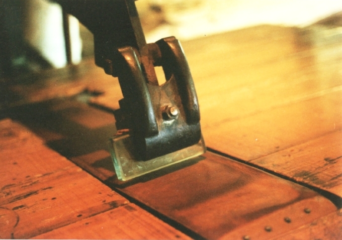 Glass plate in a leather working machine. This partly replaced and augmented the slicker. This may be the scariest machine I’ve ever seen in operation. Muir McDonald Tannery, used to polish the grain of tooling leather.