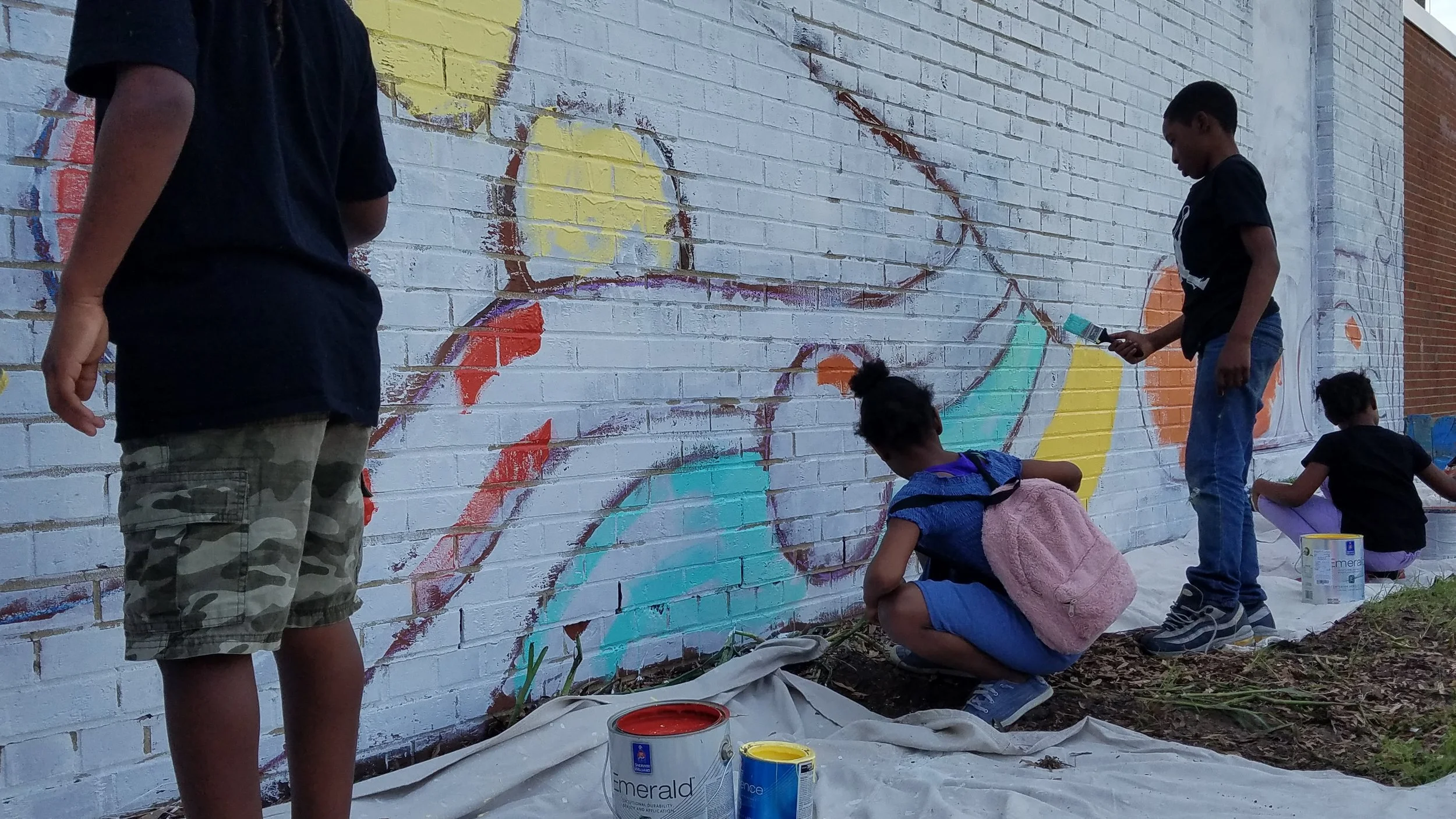 Members helped paint the mural during the Love Your Block celebration.