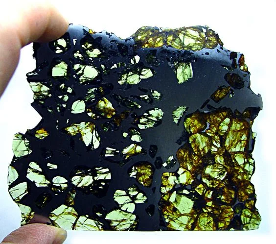Peridot in a cut from an iron and rock meteorite 