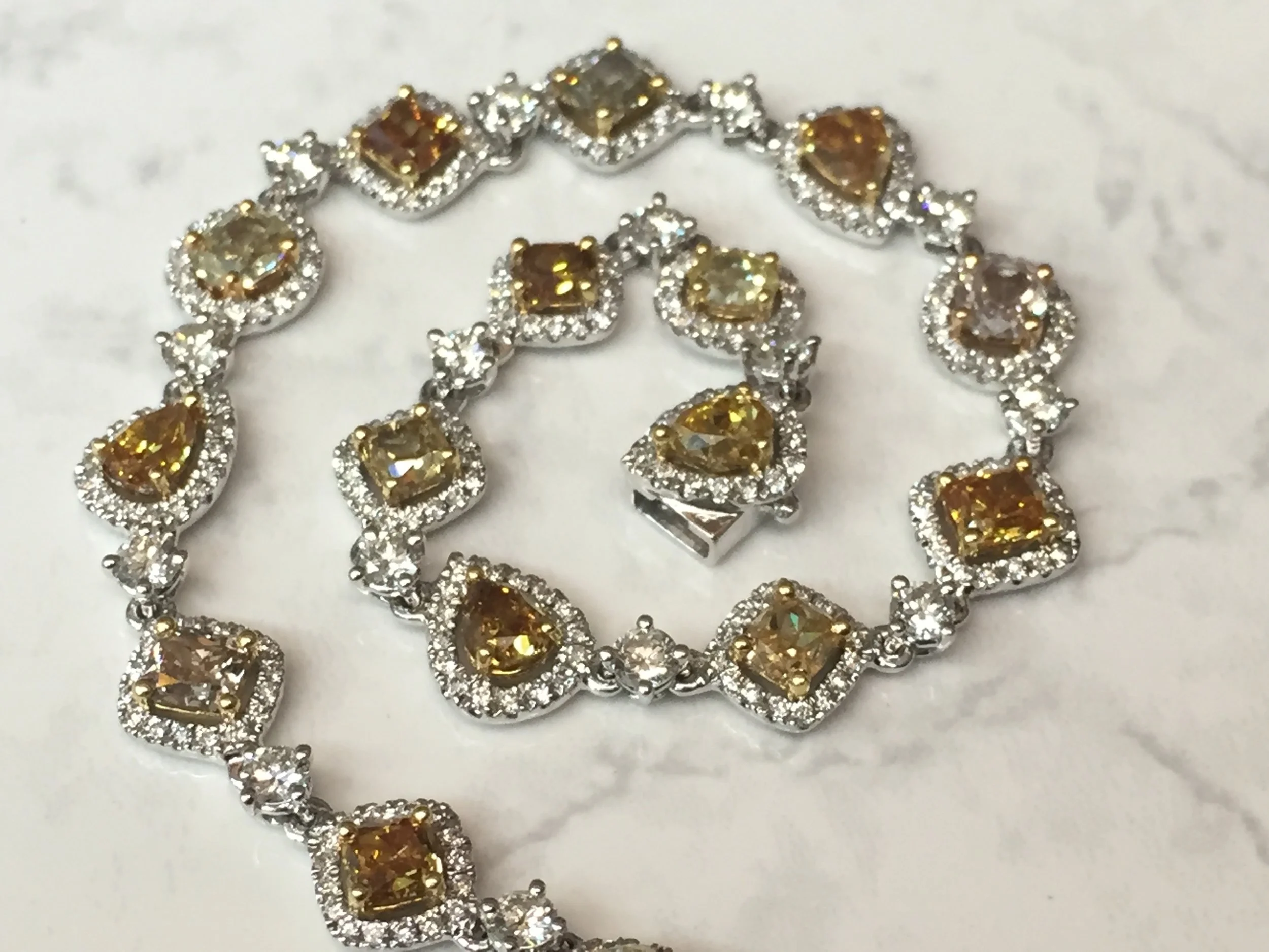 Elegant multi-colored 5.74 ctw diamond bracelet in 18K white gold. $22,800.00