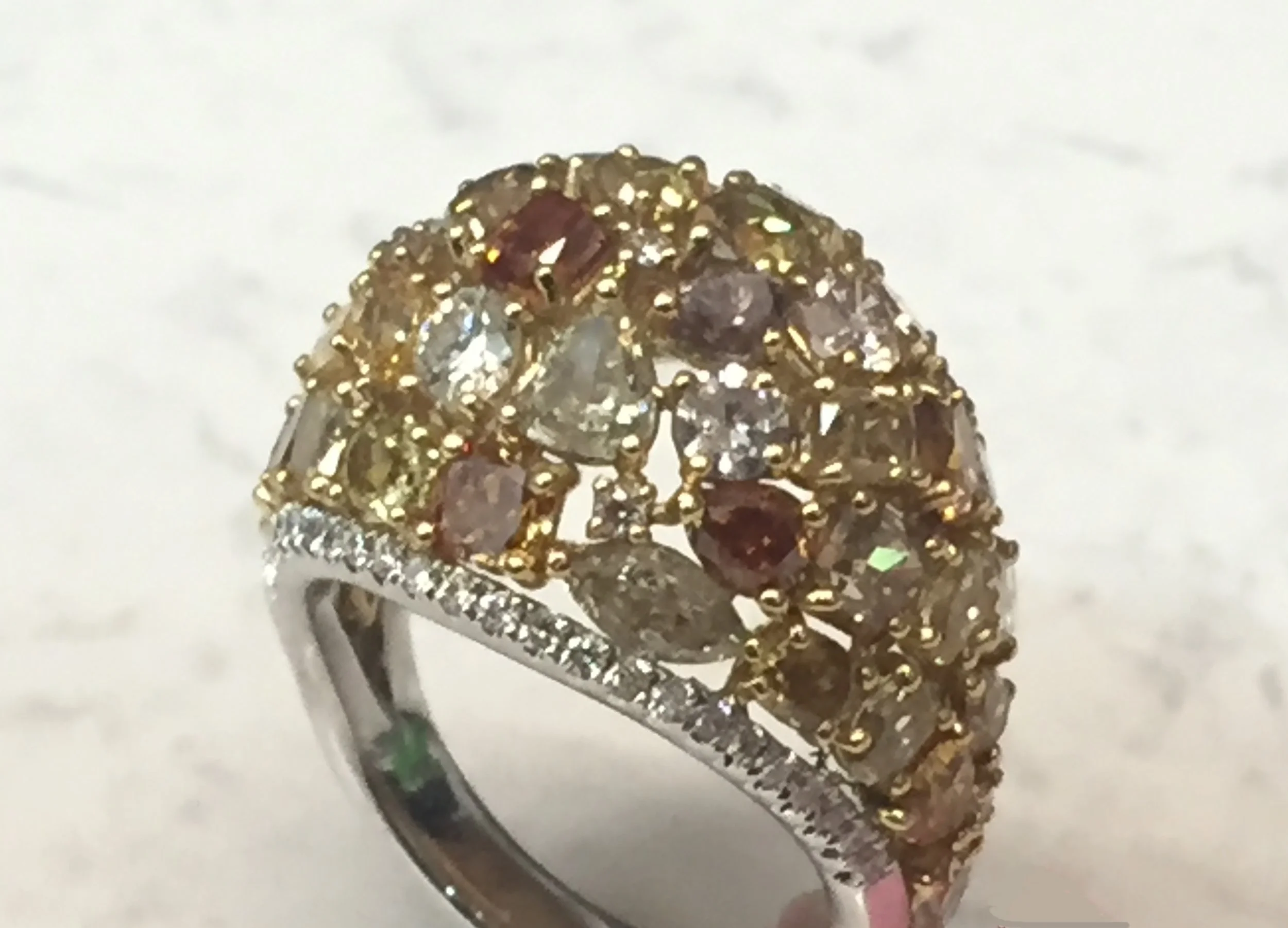 Multi-colored dome ring with 7.26 ctw diamonds, featuring yellow, cognac, and white diamonds; 18K white gold shank. $23,676.00