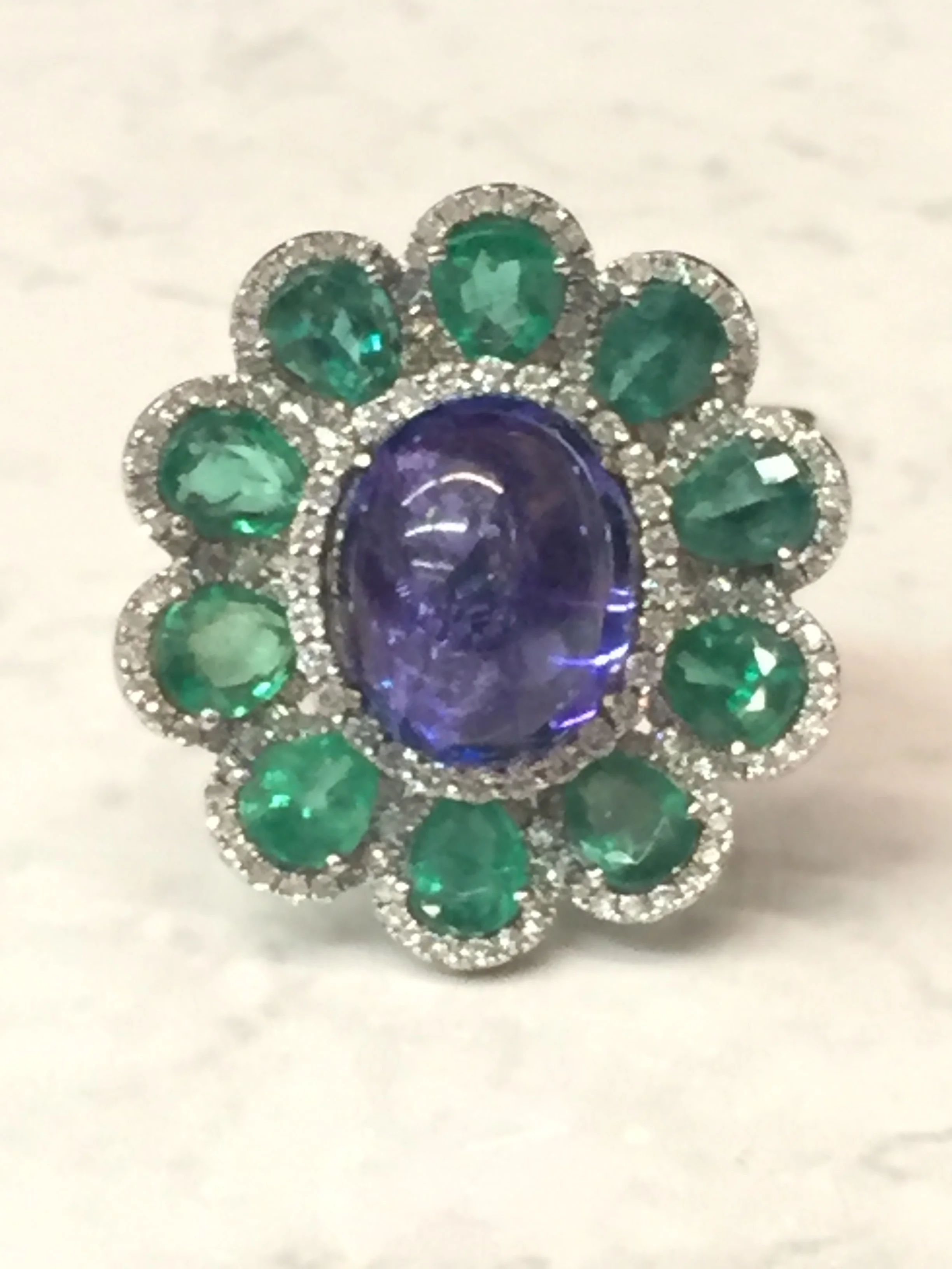 Unique tanzanite (6.97 ct) emerald (3.44 ctw) and diamond (0.74 ctw) ring in 18K white gold. $8,500.00 