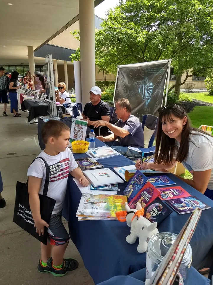 Lisa signing books for a young customer, and a look at the lovely author-lined walkway to the Sterling Heights Library. What a fun, well-organized event!