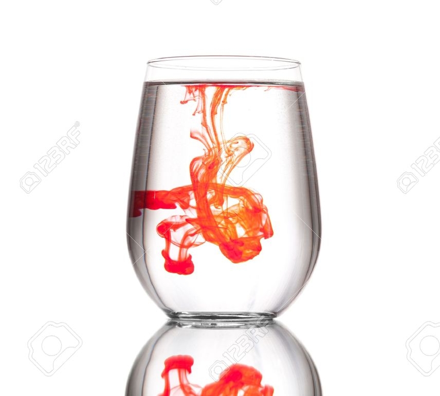 16681910-A-drop-of-red-food-coloring-in-a-glass-cup-filled-with-clear-water-against-a-white-background-Stock-Photo.jpg