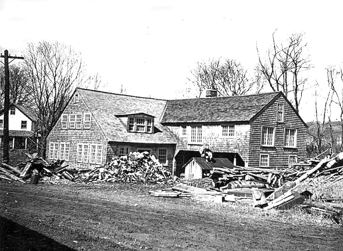 pile of sawn firewood at the mill, with housing for saw out front