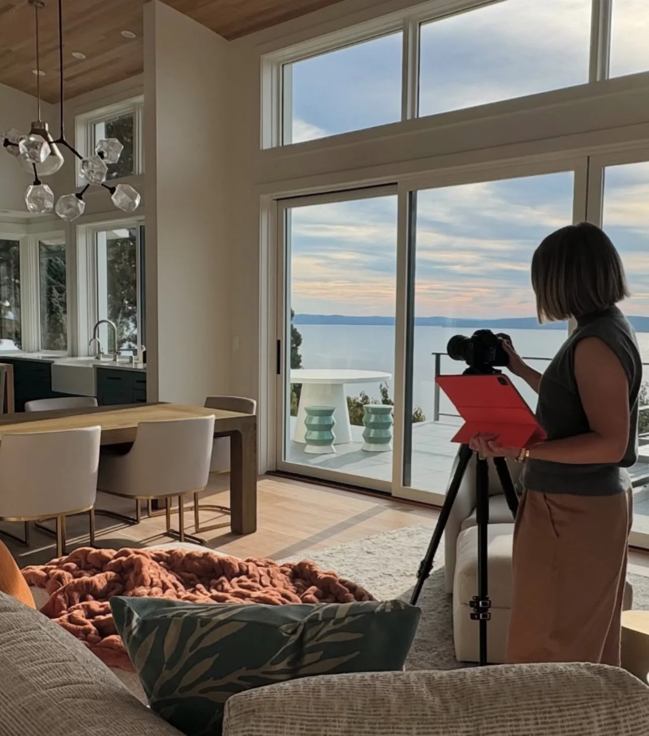 Behind-the-scenes photo of Seattle photographer Emily Keeney photographing a luxury residential interior for a commercial client.