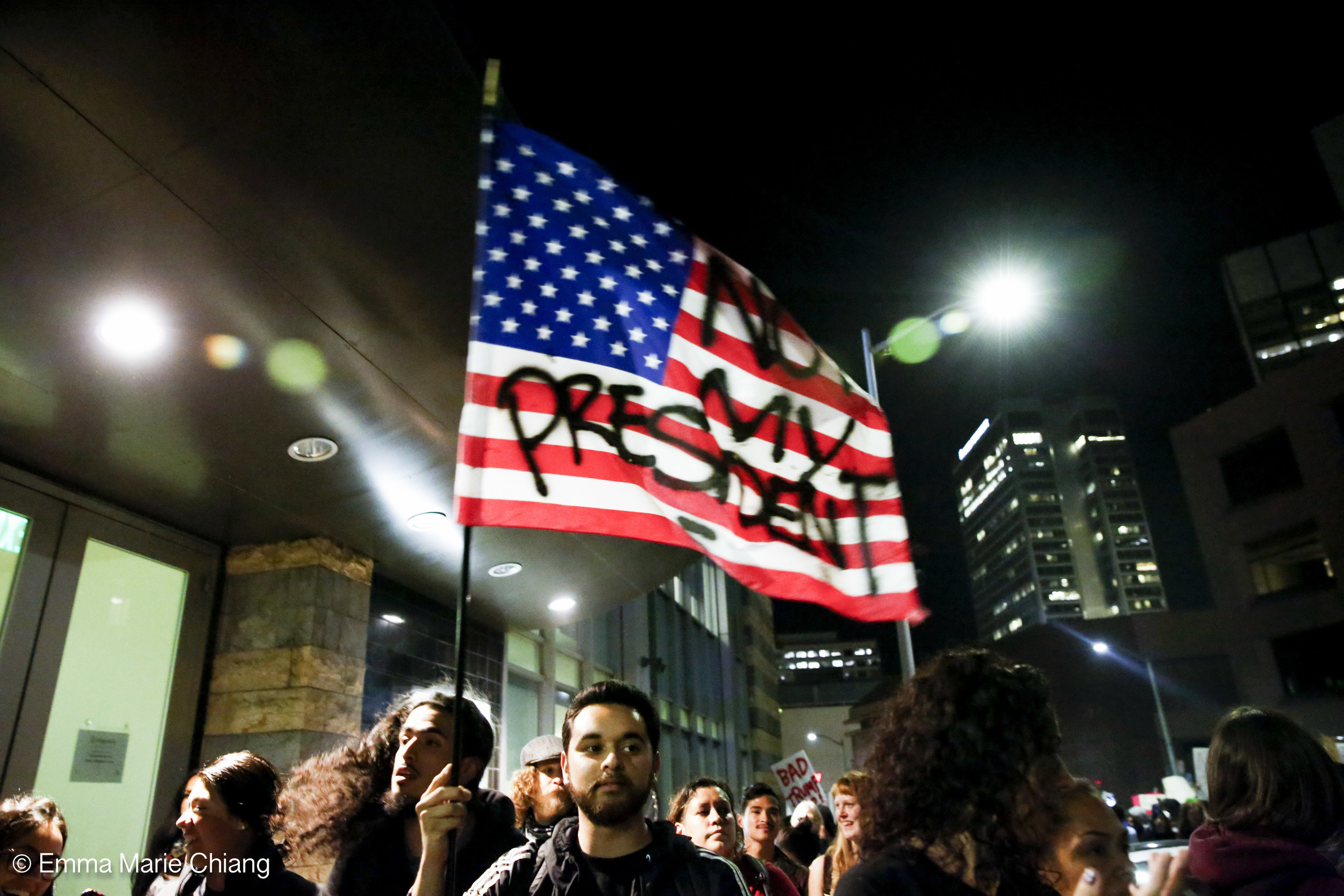  A protester waves a flag that reads "Not my America" during an anti-Trump protest through the streets of downtown Oakland Wednesday Nov. 9 2016. Photo by Emma Chiang 