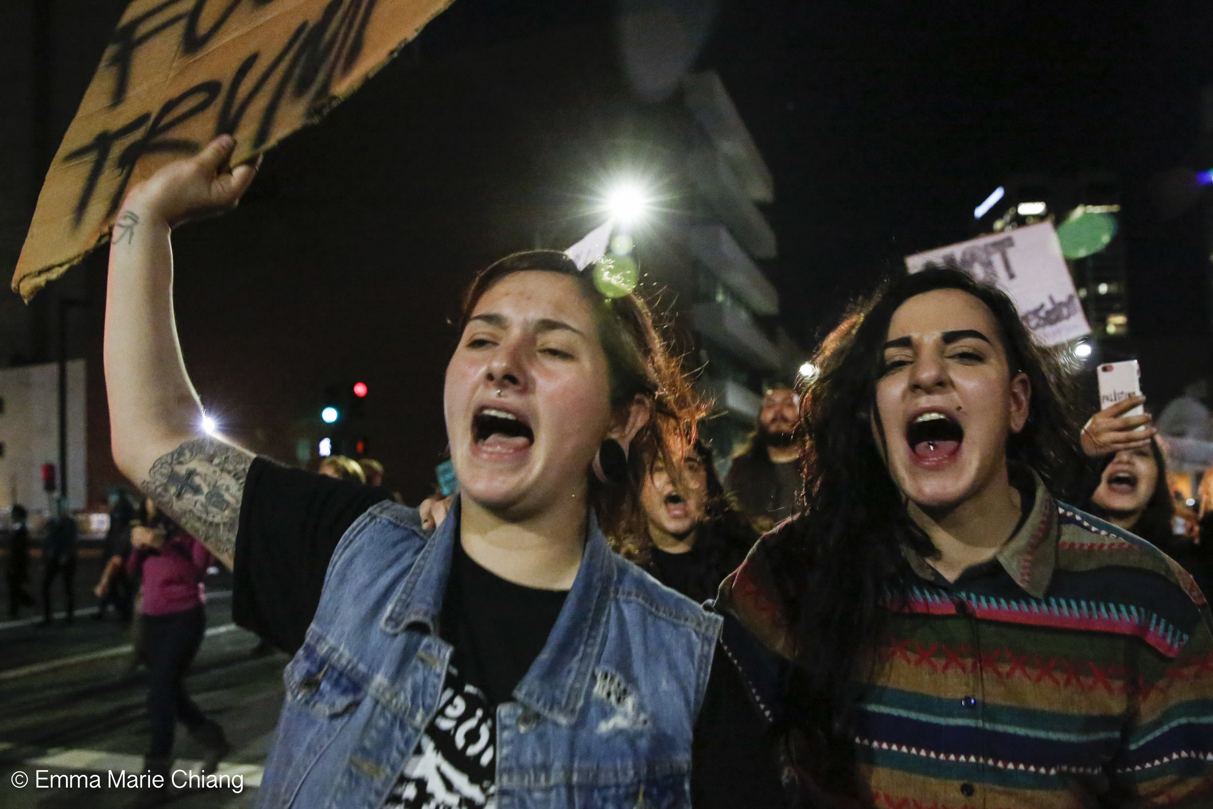  Claire Rose (left) and Angeli Chippa (right) yell "F*k Donald Trump during an anti-Trump protest through the streets of downtown Oakland Wednesday Nov. 9 2016. Photo by Emma Chiang 