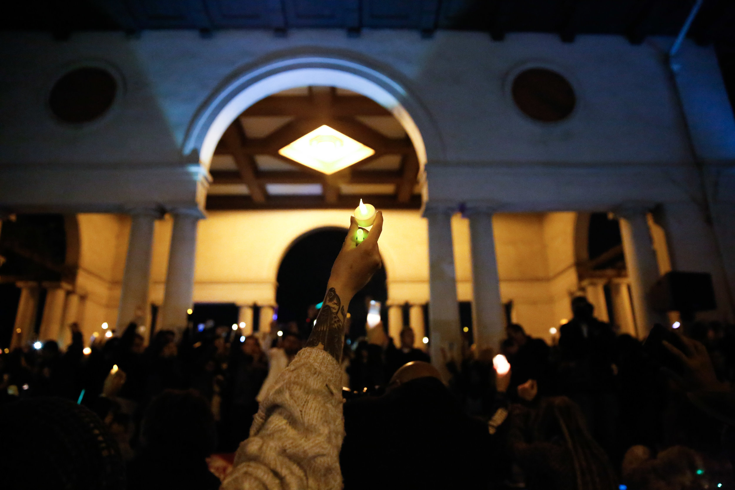  Mourners raise candles during a moment of silence at the vigil at Lake Merritt Pergola on Monday December 5, 2016. in honor of the 36 people who died in the Oakland Fire at the Ghost Ship warehouse party Friday, December 2.&nbsp; 