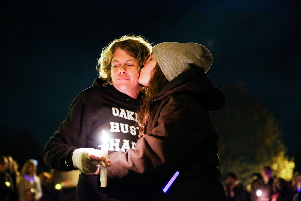  Mourners embrace each other during a vigil for the victims of the fatal warehouse fire during a vigil at Lake Merritt Pergola in Oakland, California, U.S. December 5, 2016. 