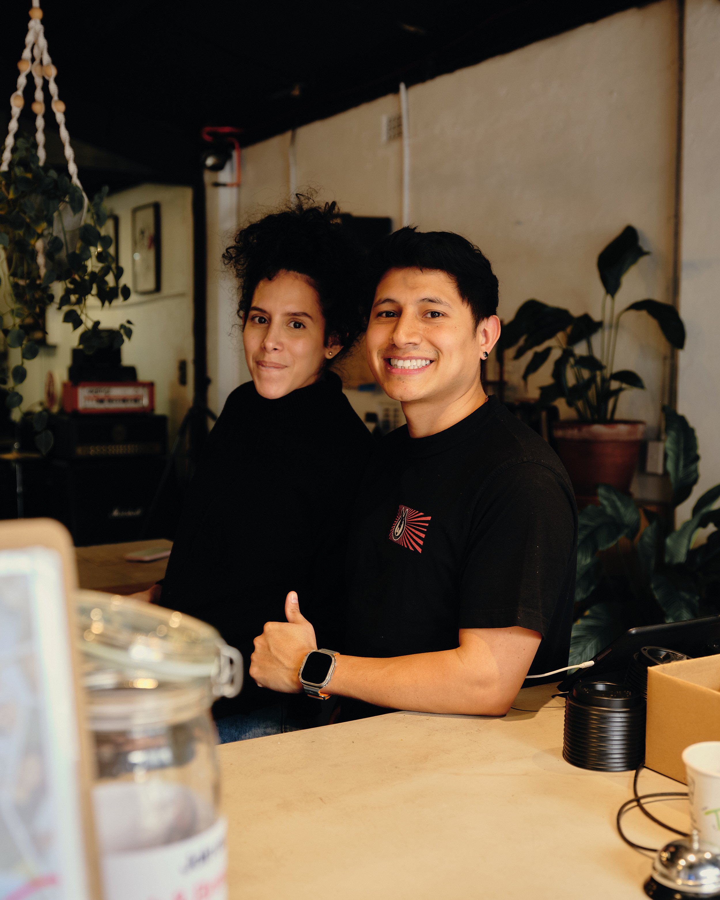 2 baristas smiling at our warehouse