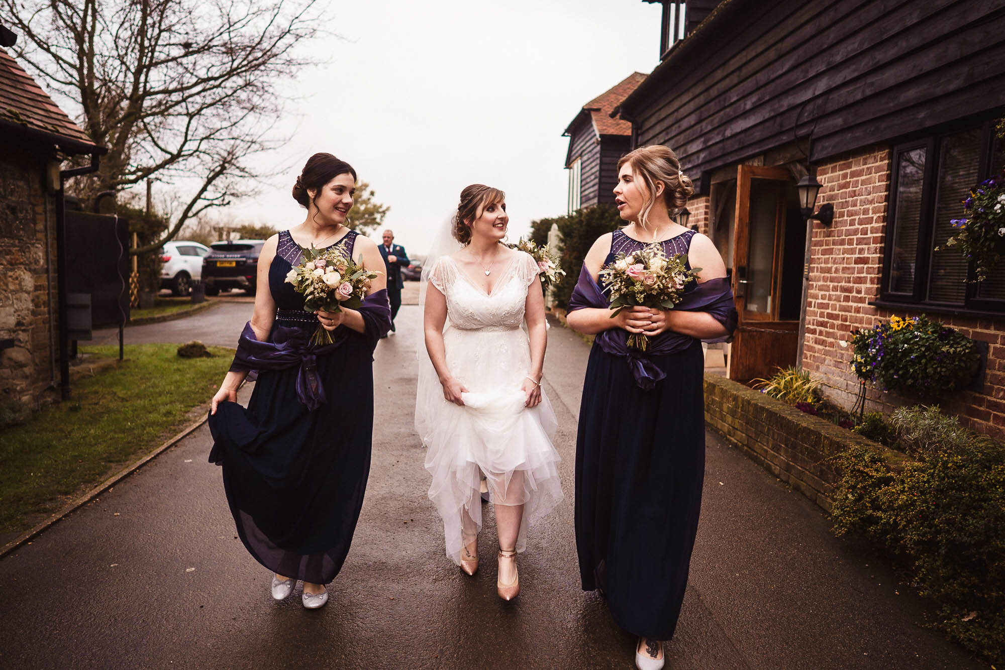 bride and bridesmaid walk to the ceremony