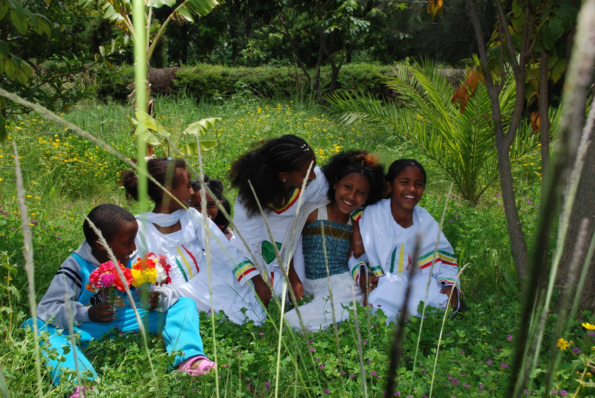 Children sharing a moment in the library's garden.